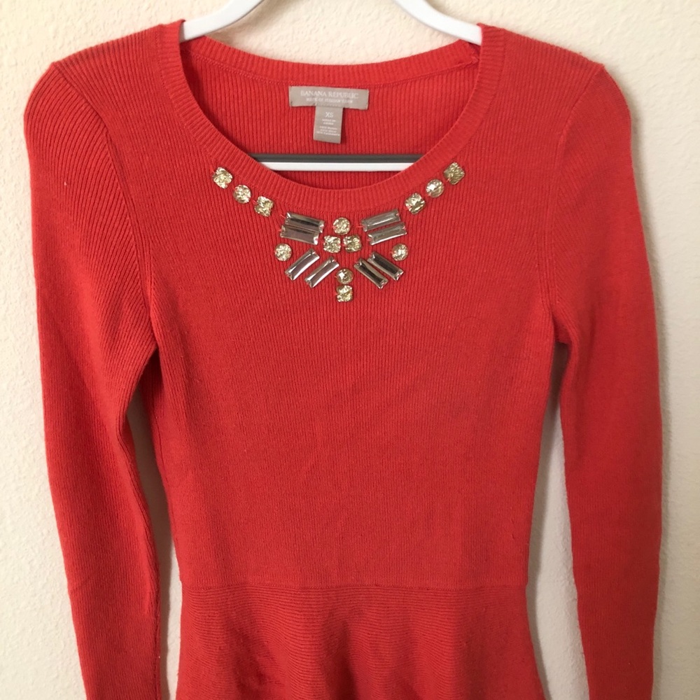 Peplum sweater with embellishments on the neck